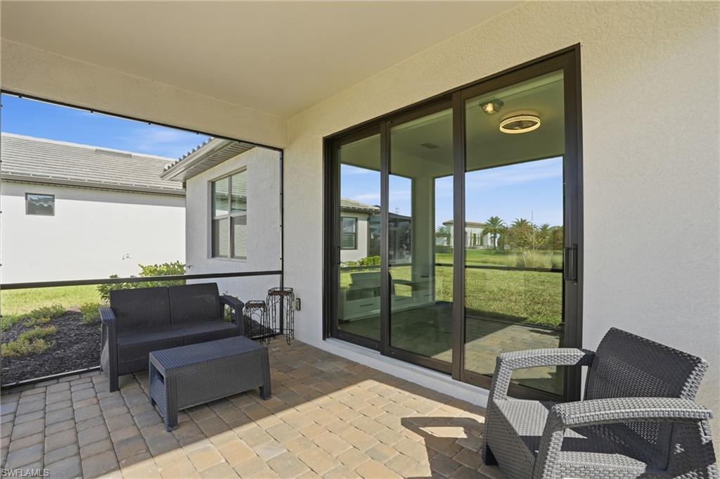 1645 Serena Avenue Naples, FL 34120 - Photo 29 of 43 a living room with furniture and a gate