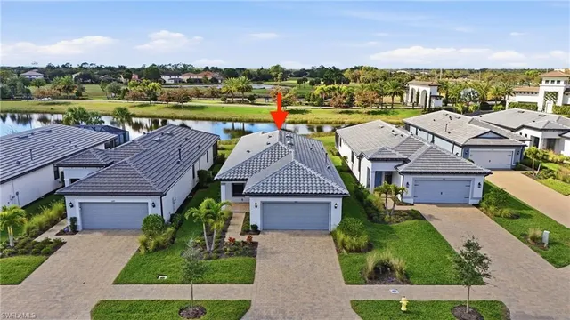 an aerial view of multiple houses with a yard