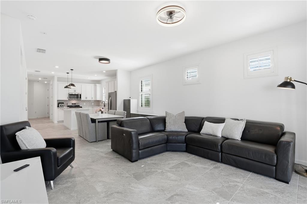 1645 Serena Avenue Naples, FL 34120 - Photo 5 of 43 a living room with furniture and kitchen view