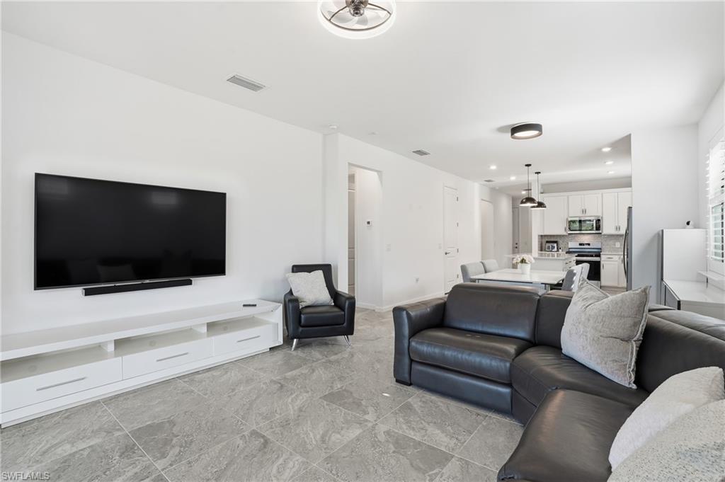 1645 Serena Avenue Naples, FL 34120 - Photo 6 of 43 a living room with furniture and a flat screen tv