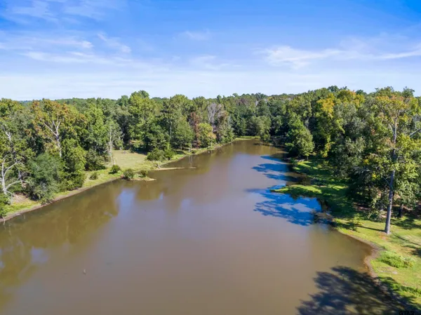a view of a lake with houses in the back