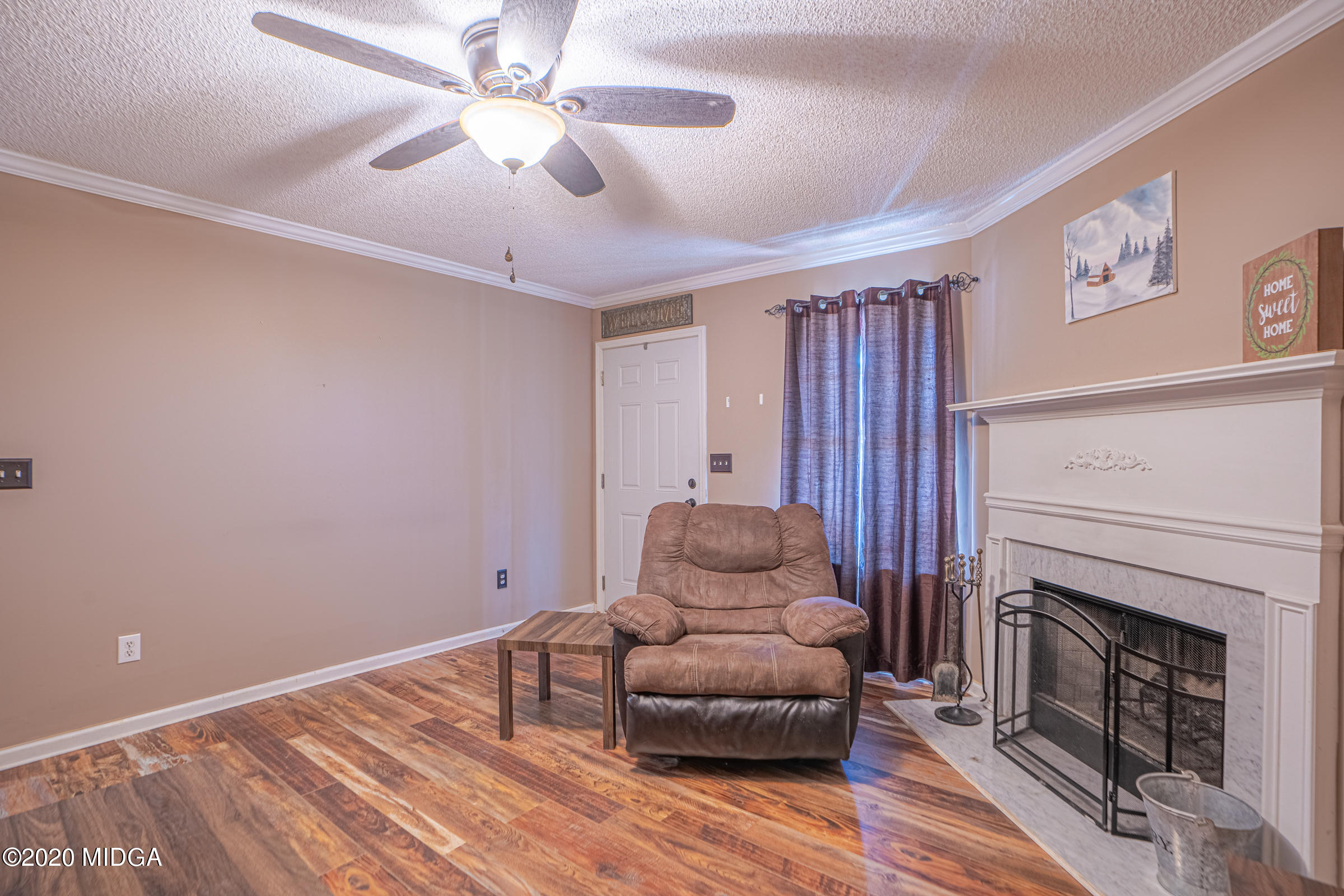 326 Autumn Ridge Trail Gray, GA 31032 - Photo 22 of 33 a living room with furniture and a fireplace