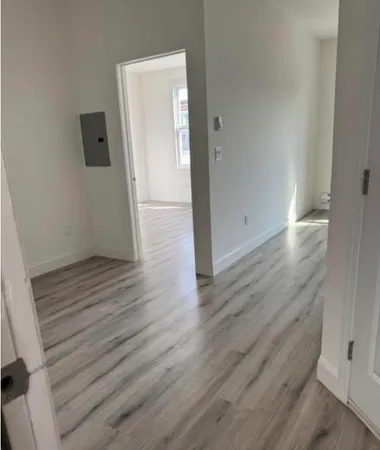a view of a room with wooden floor and staircase