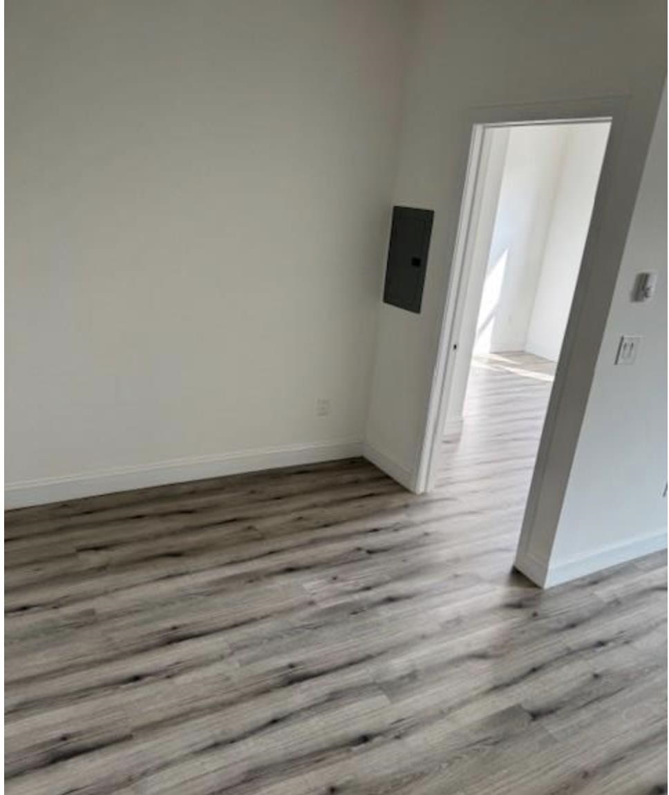 315 70th Street Guttenberg, NJ 07093 - Photo 3 of 8 a view of a room with wooden floor and staircase