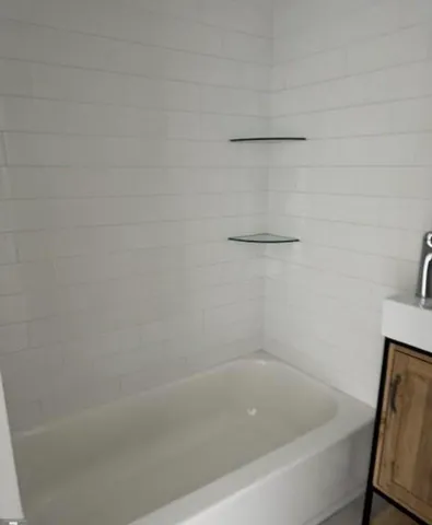 a view of a hallway with wooden floor and entryway