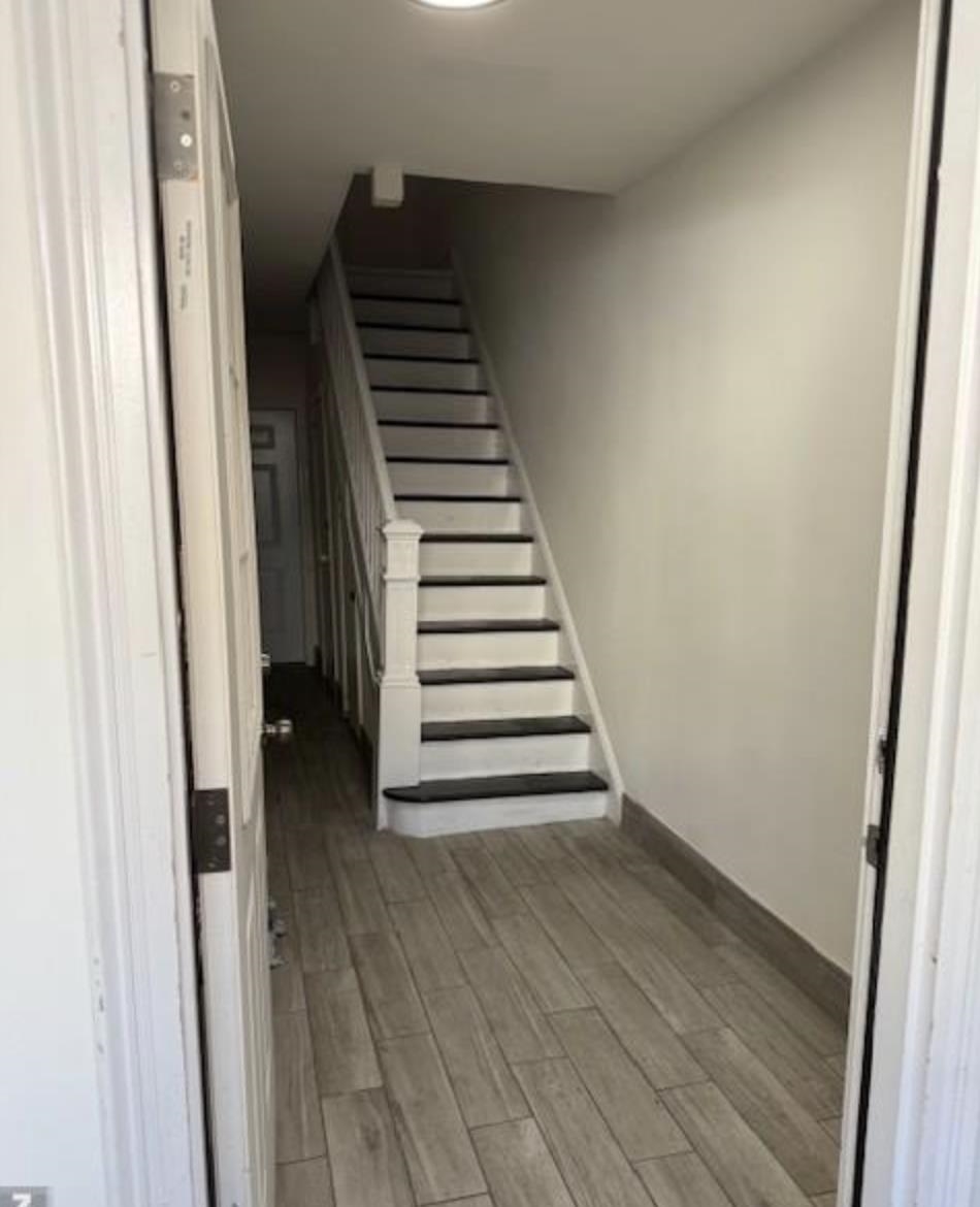 315 70th Street Guttenberg, NJ 07093 - Photo 8 of 8 a view of a hallway with wooden floor and entryway