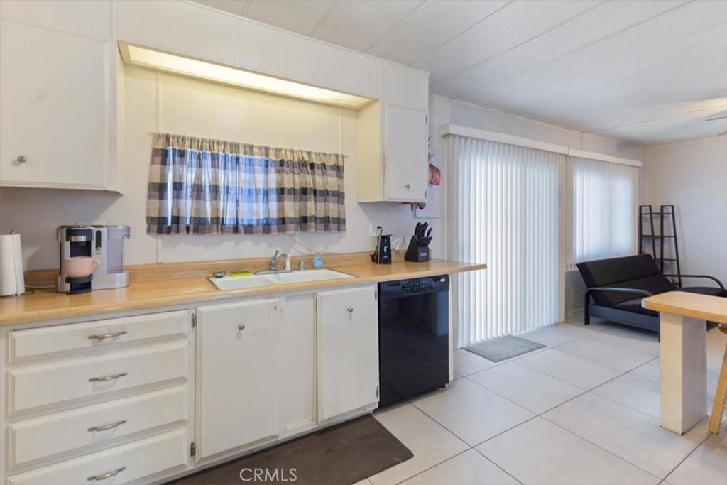 300 North Rampart Street, Unit 195 Orange, CA 92868 - Photo 4 of 25 a kitchen with a sink and cabinets