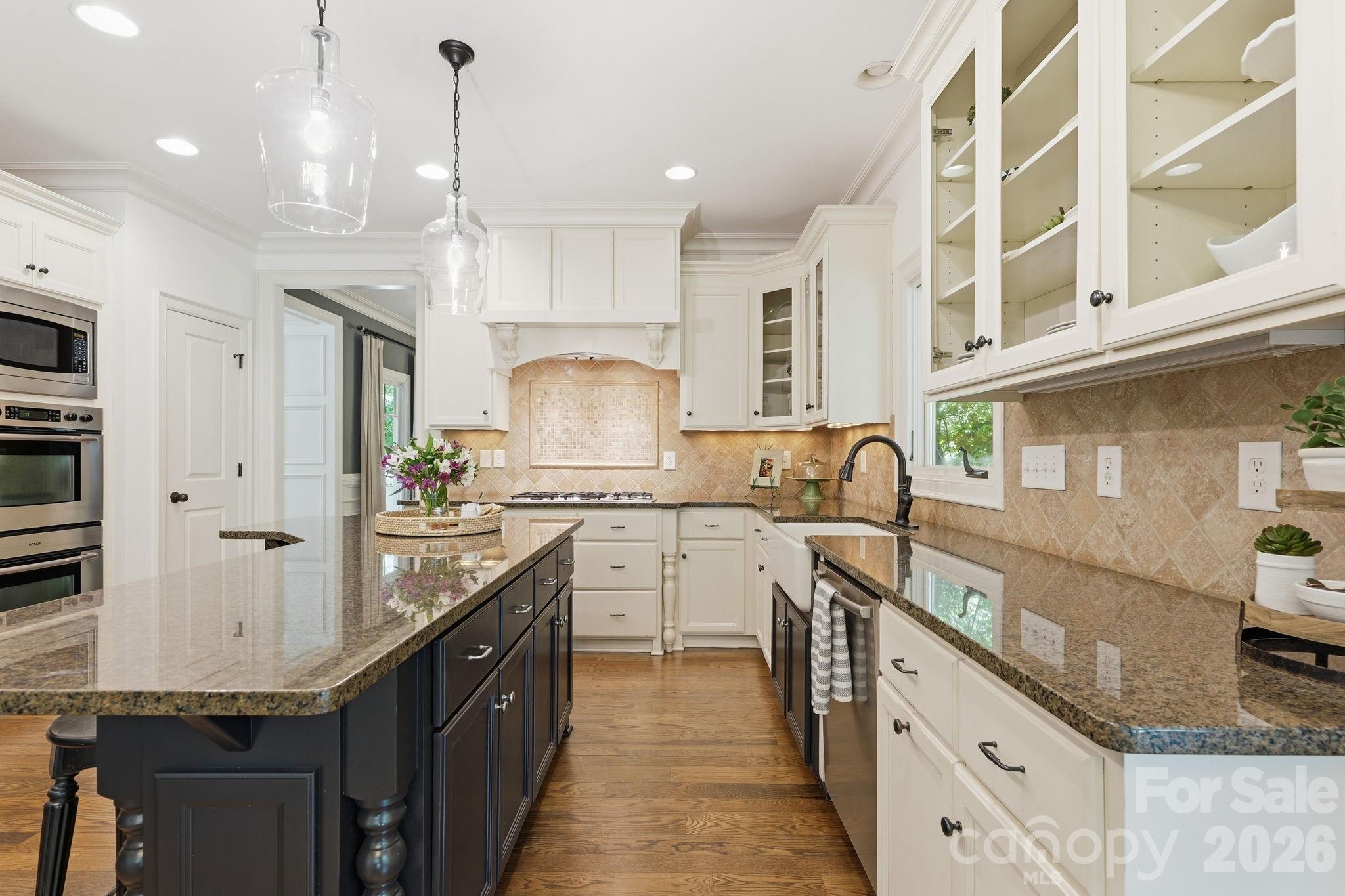 235 Grey Road Davidson, NC 28036 - Photo 9 of 42 a kitchen with stainless steel appliances granite countertop a sink a stove and a wooden floors