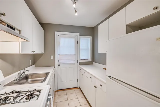 a kitchen with a sink stove and refrigerator