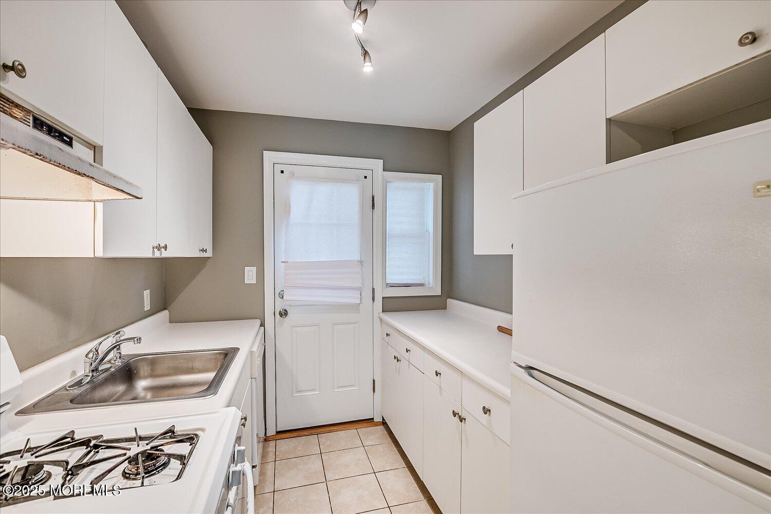 31 Cedar Avenue, Unit 11 Long Branch, NJ 07740 - Photo 12 of 19 a kitchen with a sink stove and refrigerator