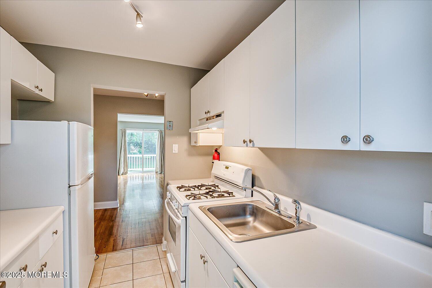 31 Cedar Avenue, Unit 11 Long Branch, NJ 07740 - Photo 13 of 19 a kitchen that has a sink and a stove
