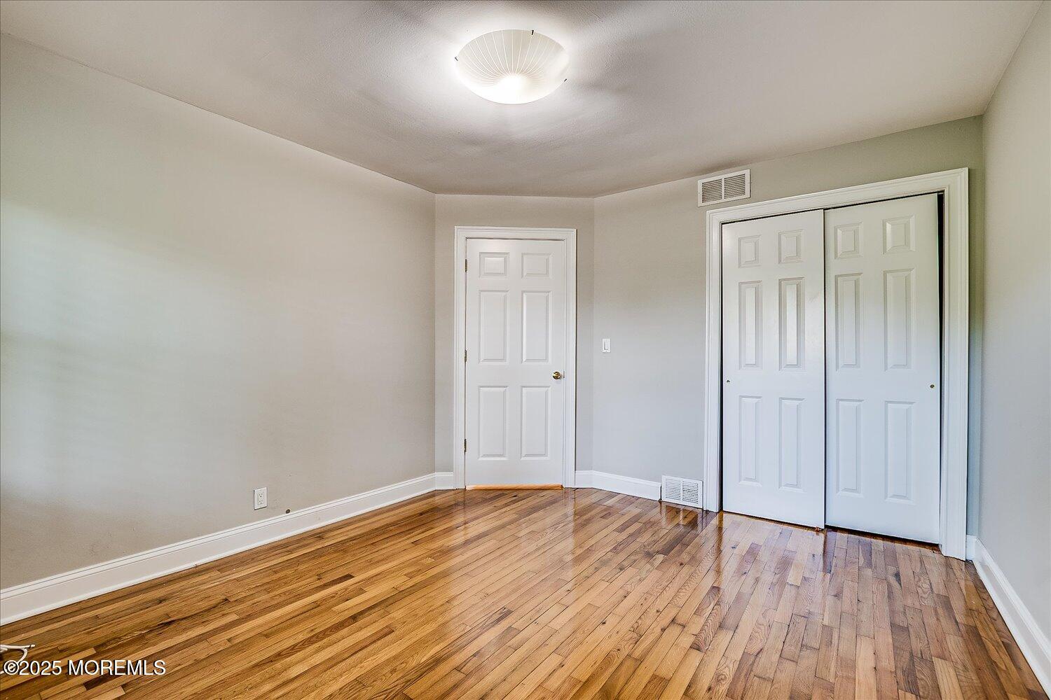 31 Cedar Avenue, Unit 11 Long Branch, NJ 07740 - Photo 15 of 19 a view of an empty room with wooden floor