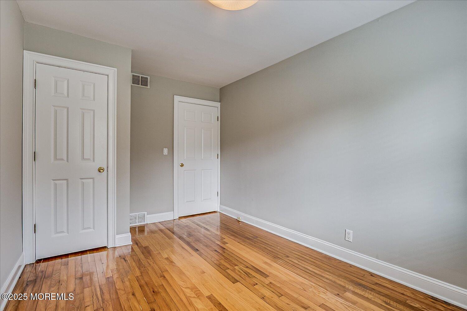 31 Cedar Avenue, Unit 11 Long Branch, NJ 07740 - Photo 18 of 19 a view of empty room with wooden floor