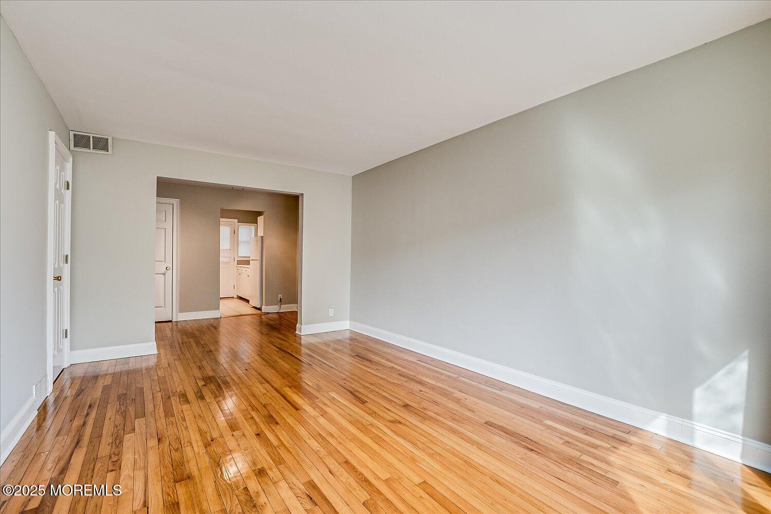 31 Cedar Avenue, Unit 11 Long Branch, NJ 07740 - Photo 6 of 19 a view of empty room with wooden floor