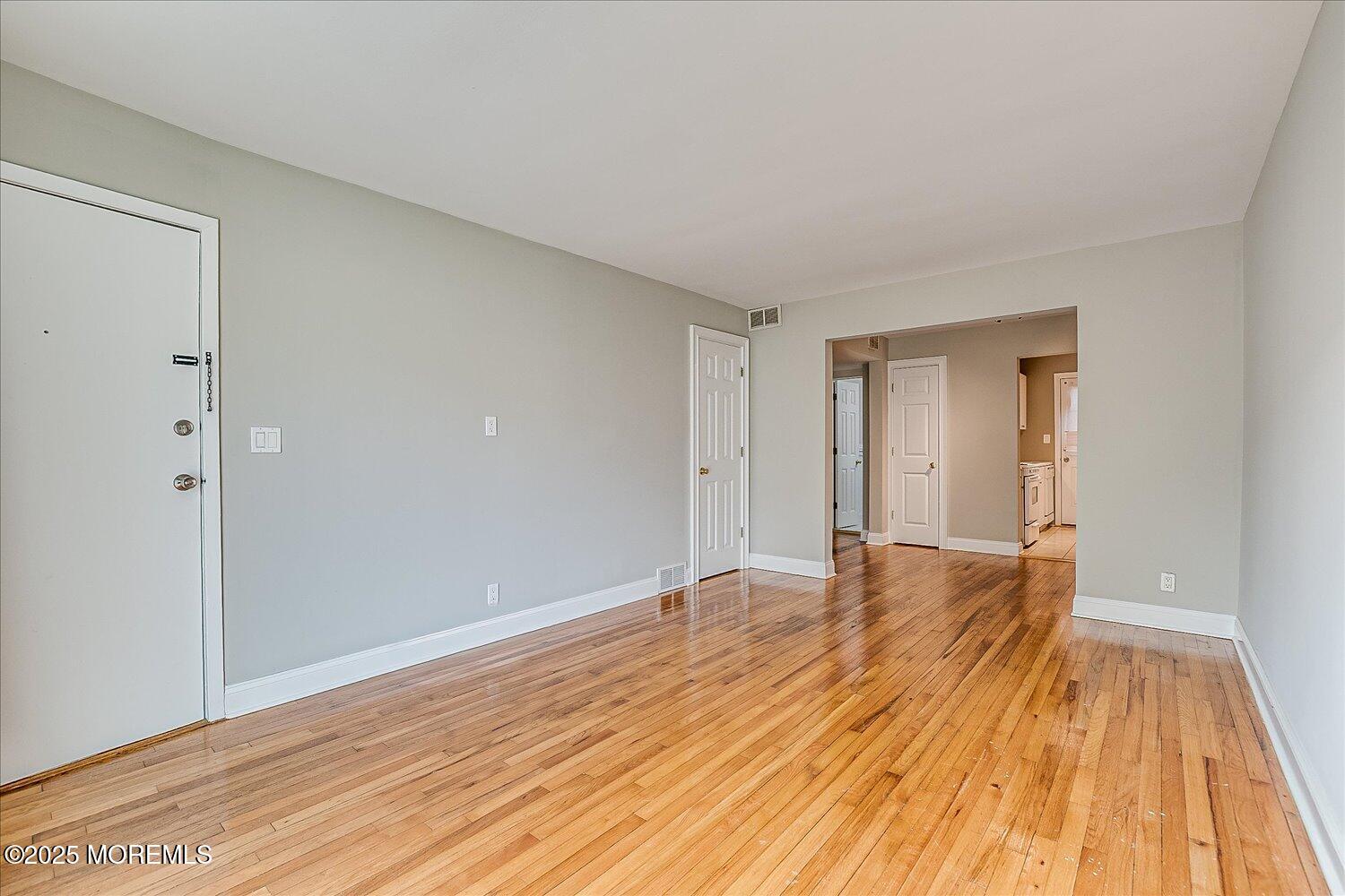 31 Cedar Avenue, Unit 11 Long Branch, NJ 07740 - Photo 7 of 19 a view of an empty room with wooden floor and closet