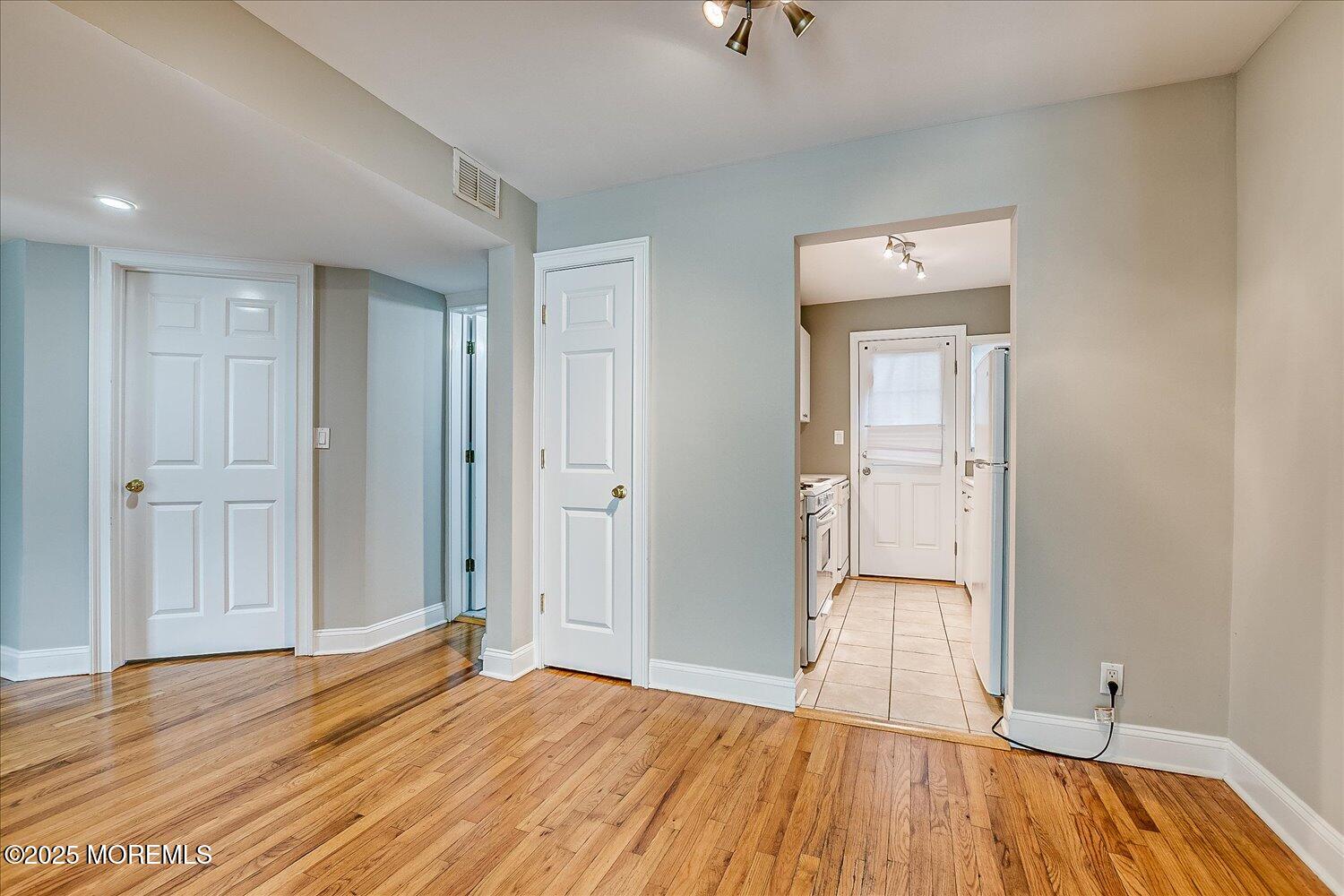 31 Cedar Avenue, Unit 11 Long Branch, NJ 07740 - Photo 8 of 19 a view of empty room with wooden floor