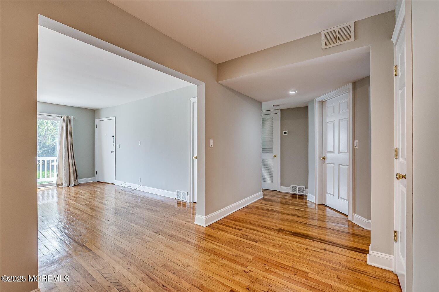31 Cedar Avenue, Unit 11 Long Branch, NJ 07740 - Photo 9 of 19 a view of an empty room with wooden floor