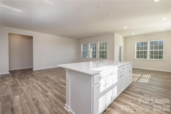 a spacious bathroom with a granite countertop sink and a large mirror