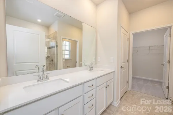 a bathroom with double sink and a mirror