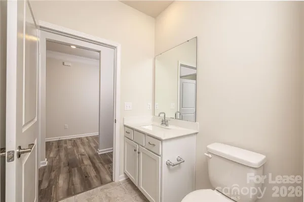 a bathroom with a sink a toilet a mirror and vanity