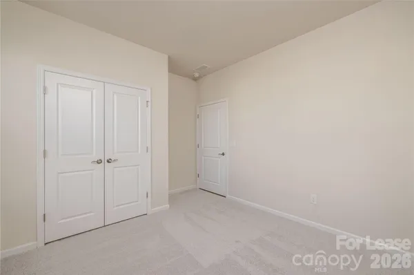 a view of an empty room and wooden floor