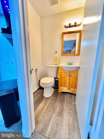 a bathroom with a toilet a sink and a mirror