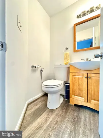 a bathroom with a toilet and a mirror