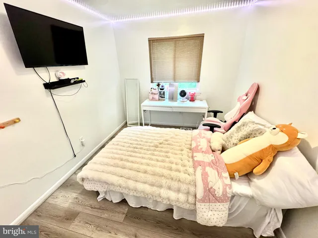 a bedroom with a bed and flat screen tv
