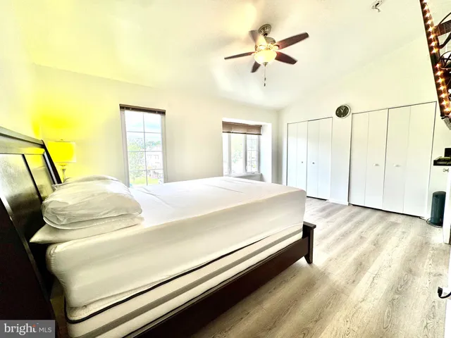 a bedroom with a bed and ceiling fan