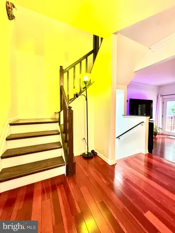 a view of entryway and hall with wooden floor