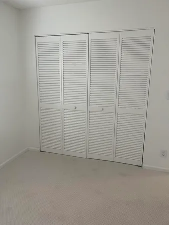 an empty room with cabinet in closet