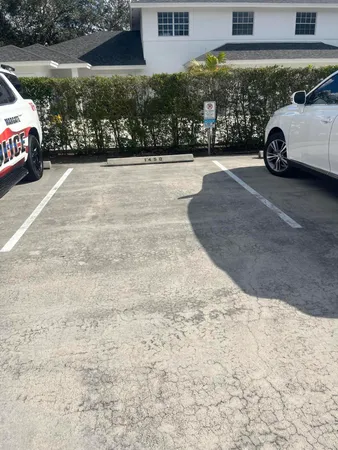 a view of a cars park in front of a building