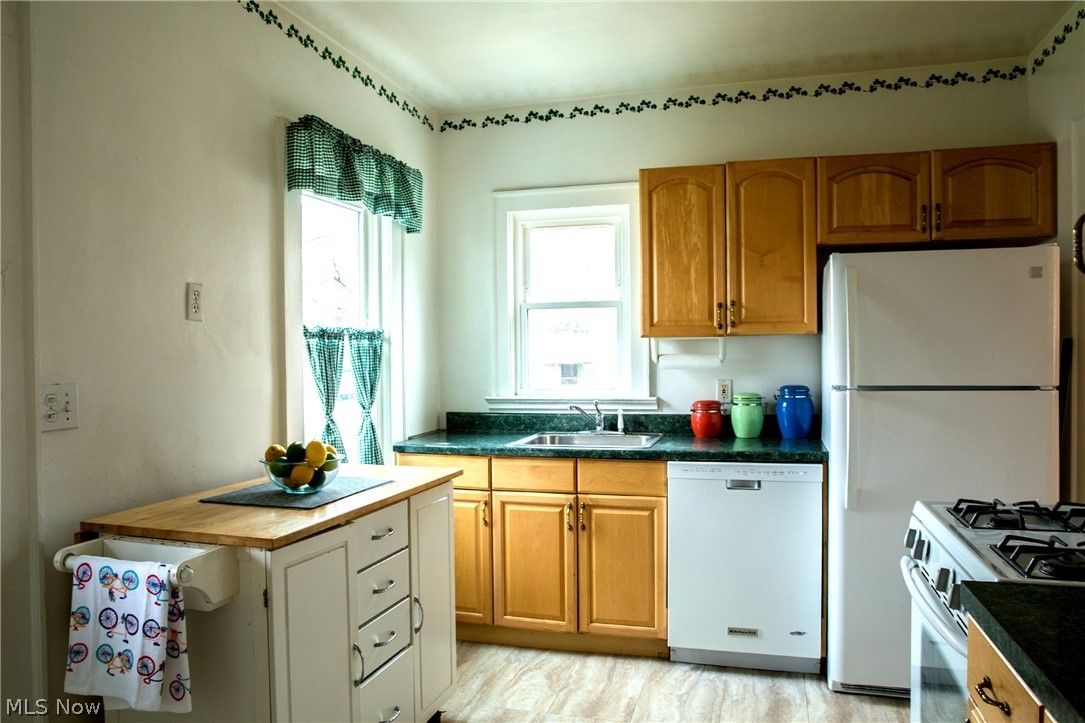 3436 Berea Road Cleveland, OH 44111 - Photo 17 of 26 The kitchen has a dishwasher (3 yrs old), a 2 year old refrigerator, two windows for better cooking light and the wood topped cabinet to the left can stay with new owners for even more workspace.
