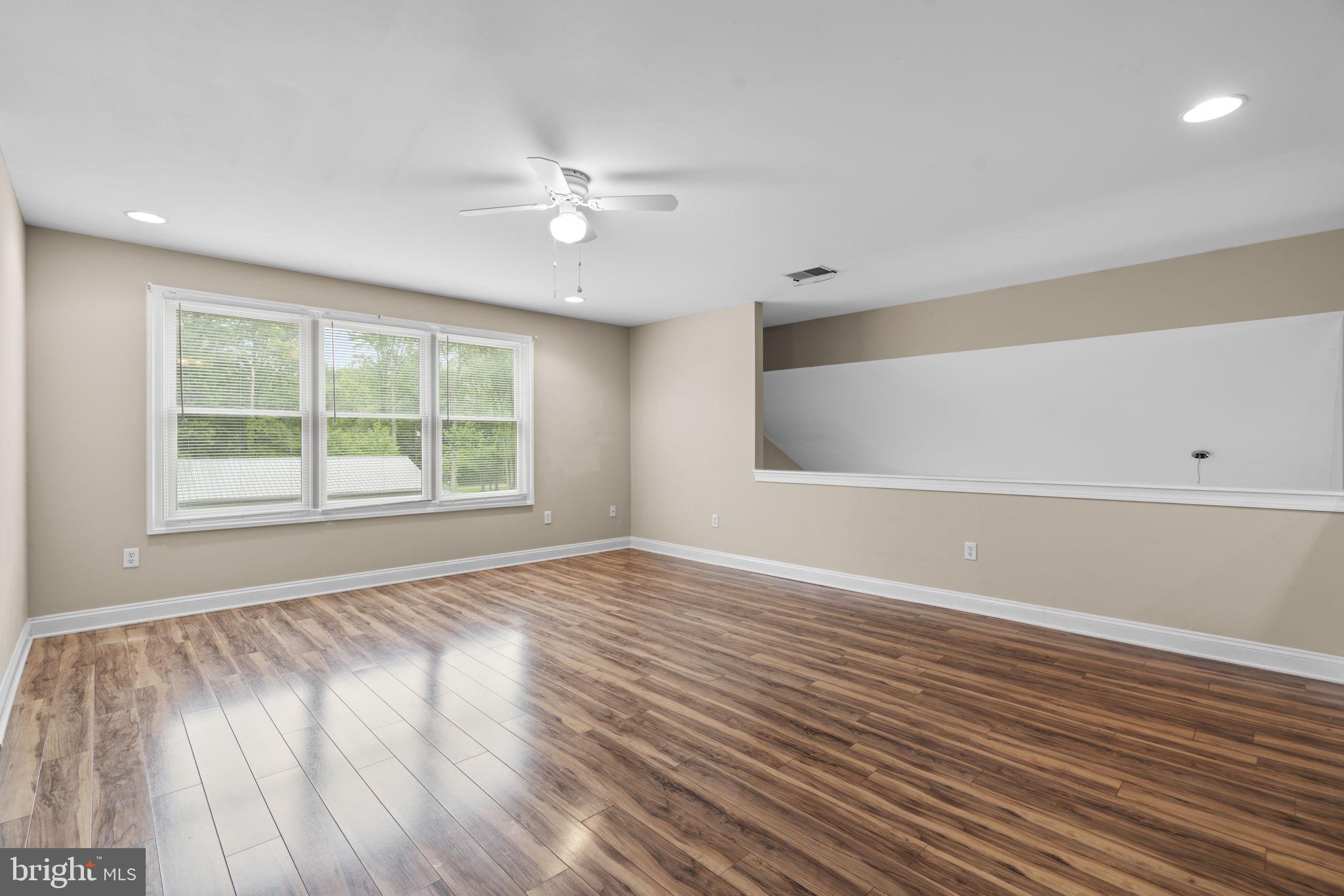 8024 Solley Road Glen Burnie, MD 21060 - Photo 48 of 83 a view of an empty room with wooden floor and a window