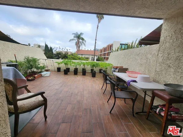 a view of a chairs and table in patio
