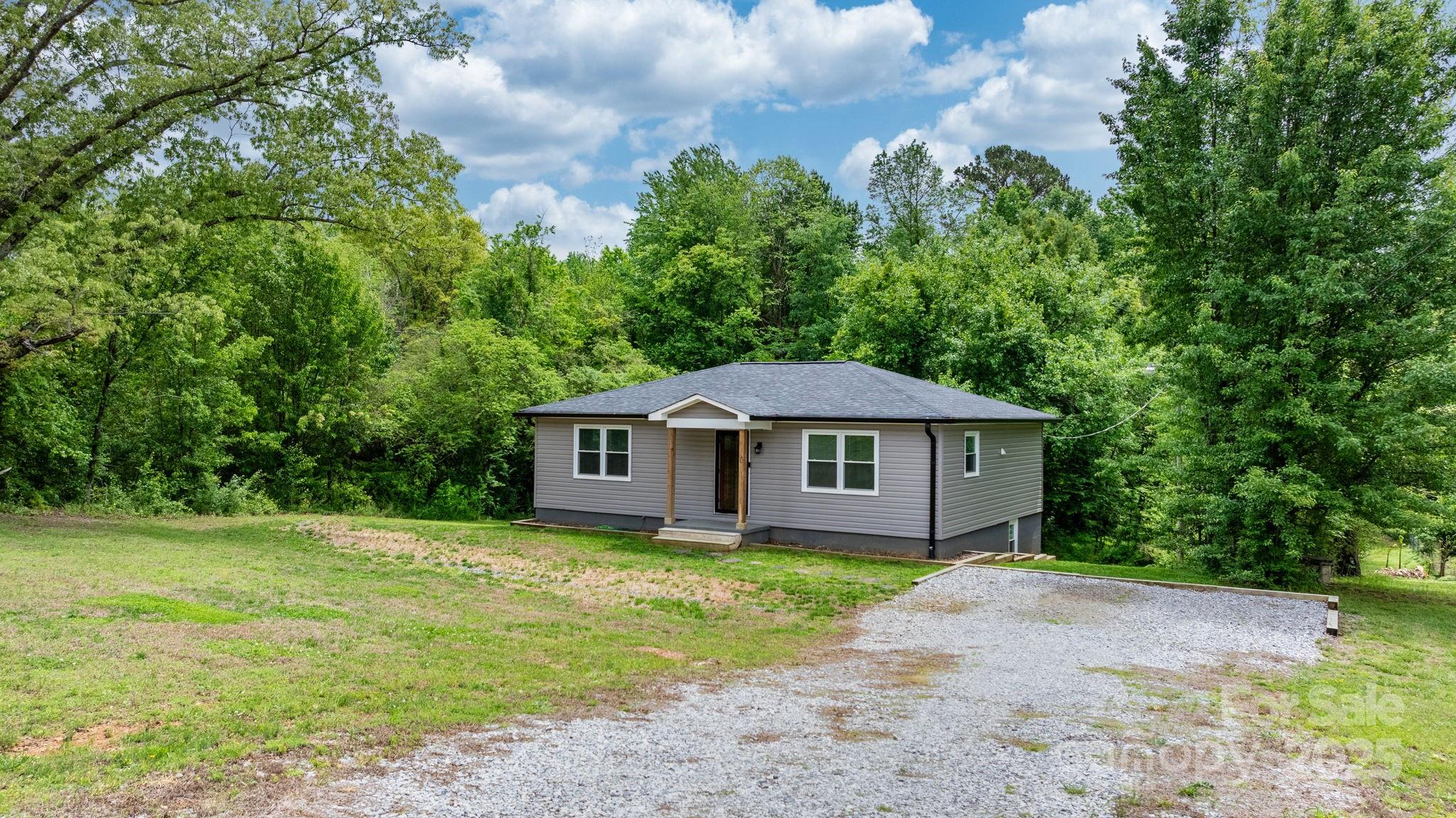 2473 Israel Chapel Road Connelly Springs, NC 28612 - Photo 2 of 37 a house with trees in the background
