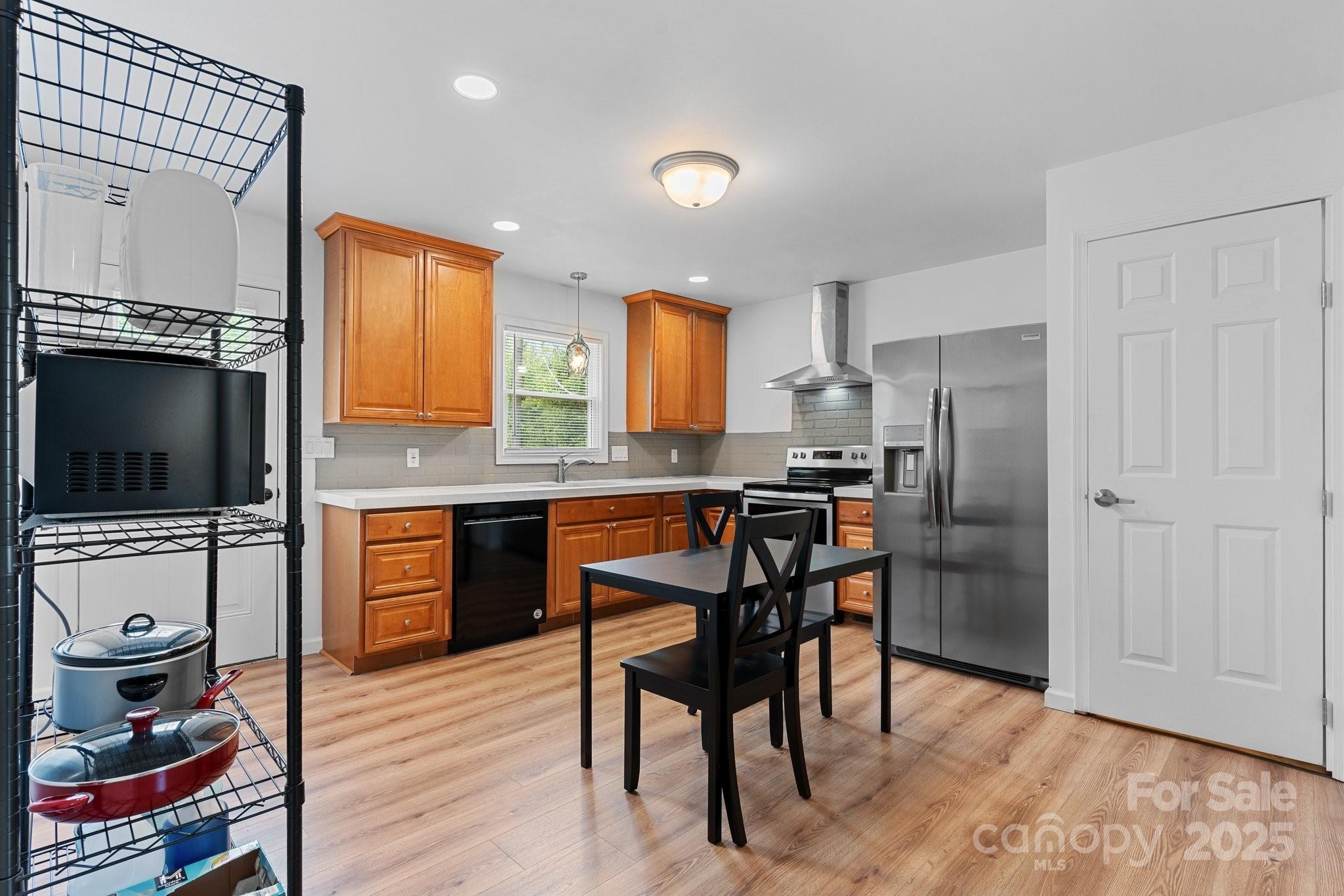 2473 Israel Chapel Road Connelly Springs, NC 28612 - Photo 9 of 37 a kitchen with refrigerator cabinets and wooden floor