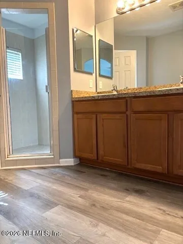 a view of a bathroom with a sink and a mirror