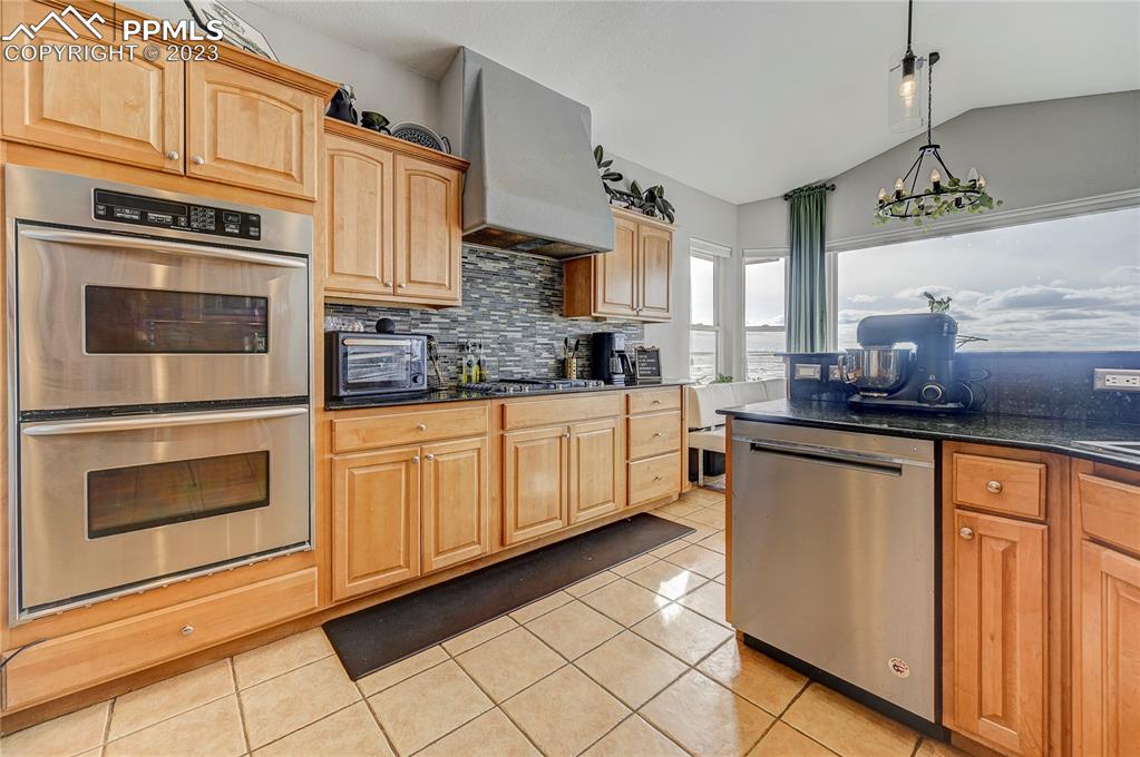 8640 Berridge Road Calhan, CO 80808 - Photo 12 of 50 a kitchen with stainless steel appliances a stove sink and cabinets