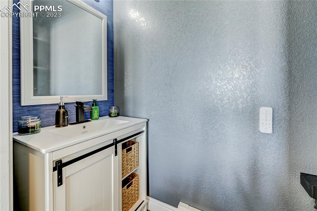 8640 Berridge Road Calhan, CO 80808 - Photo 26 of 50 a bathroom with a sink and a mirror