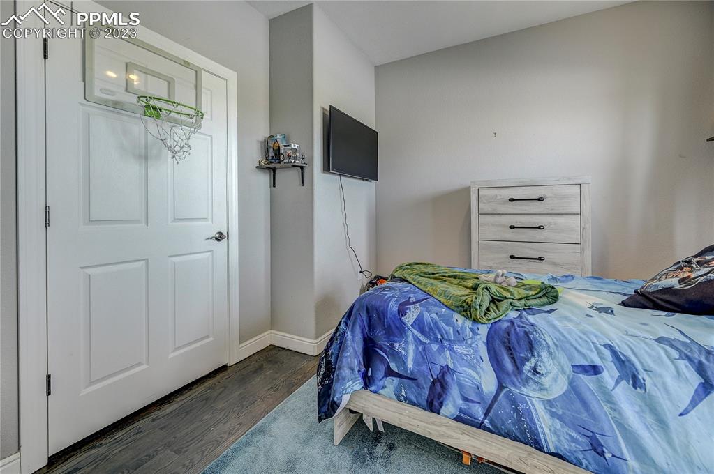 8640 Berridge Road Calhan, CO 80808 - Photo 27 of 50 a bedroom with a bed and a flat tv screen