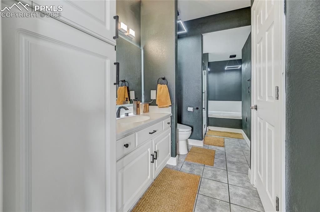 8640 Berridge Road Calhan, CO 80808 - Photo 38 of 50 a spacious bathroom with a double vanity sink and a mirror