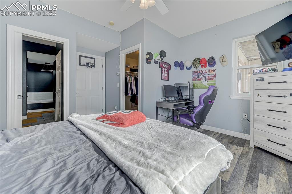 8640 Berridge Road Calhan, CO 80808 - Photo 40 of 50 a bedroom with a bed and a flat screen tv