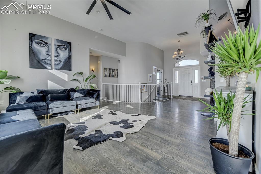 8640 Berridge Road Calhan, CO 80808 - Photo 6 of 50 a living room with furniture potted plant and a chandelier