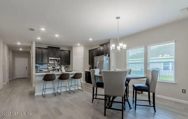 a kitchen with a table and chairs in it