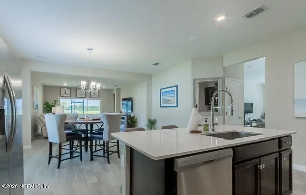 a kitchen with stainless steel appliances kitchen island granite countertop a sink and cabinets