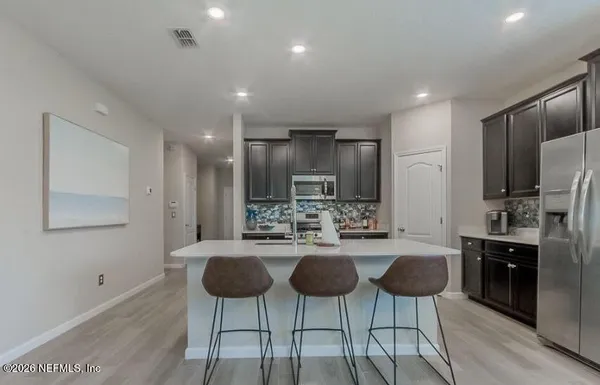 a bathroom with a granite countertop sink a shower and a mirror