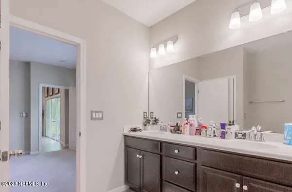 a bedroom with a large bed and a flat tv screen on dresser