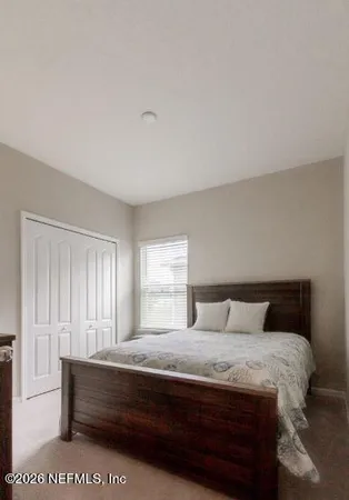 a bedroom with a bed and a tv