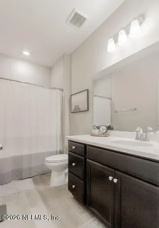 a bedroom with a bed and a toilet